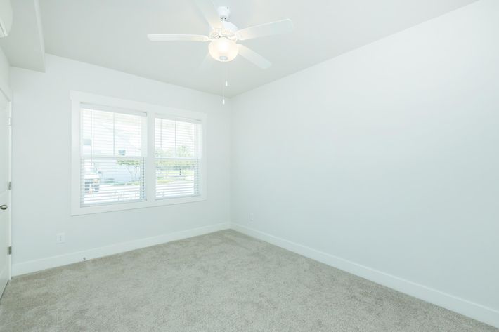 2" FAUX WOOD BLINDS AND CEILING FAN IN BEDROOM