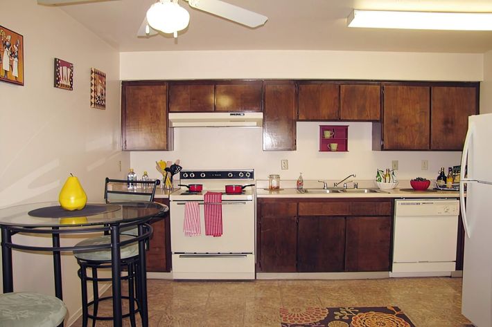 a kitchen with a stove and a refrigerator