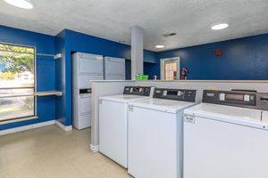 a kitchen with a refrigerator in a room