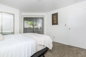 carpeted bedroom with sliding glass doors