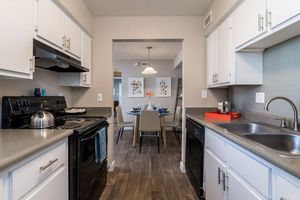 Kitchen equipped with black appliances and white cabinets at Azul Apartments in Phoenix, Arizona