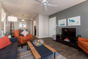 Furnished living room with ceiling fan and dining area at Azul Apartments in Phoenix, Arizona