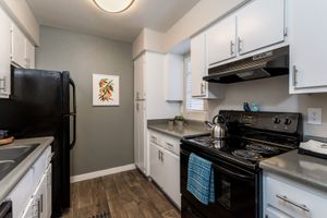 Kitchen equipped with black appliances and white cabinets at Azul Apartments in Phoenix, Arizona