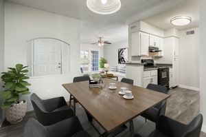 Staged dining area and kitchen with modern lighting at Azul Apartments in Phoenix, Arizona