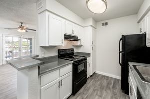 Kitchen with white cabinets and black appliances at Azul Apartments in Phoenix, Arizona