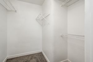 Walk-in closet with wire shelves at Azul Apartments in Phoenix, Arizona