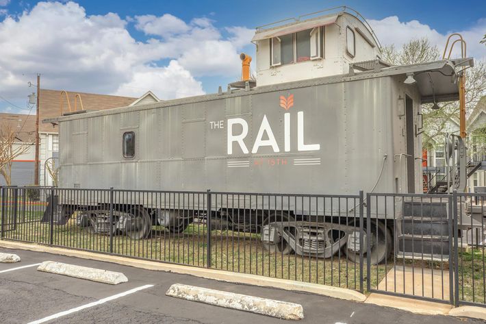 a train is parked on the side of a building