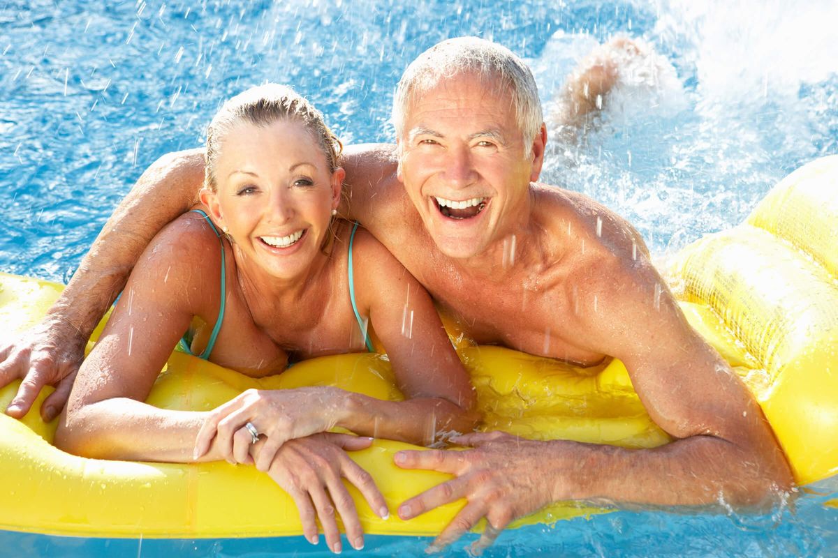 Senior couple having fun in pool iStock-121028974.jpg