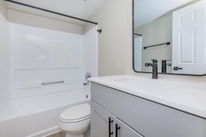 a room with a sink and a mirror