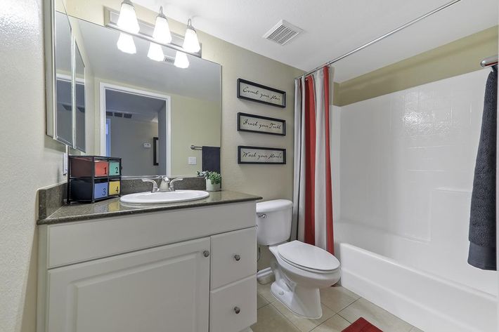 Bathroom with red and white shower curtain