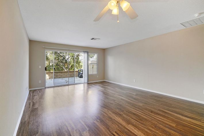 Vacant living room with sliding glass doors to patio