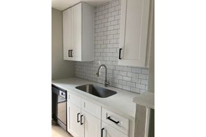 a kitchen with a sink and a mirror