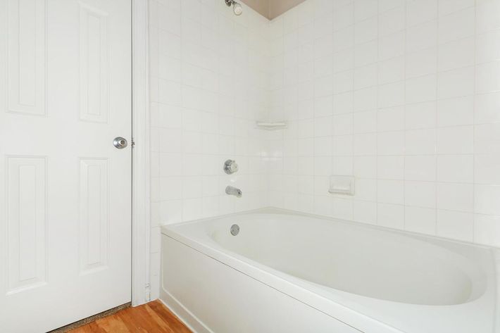 a white tub sitting next to a shower