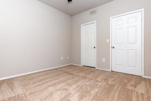 unfurnished bedroom with closed doors