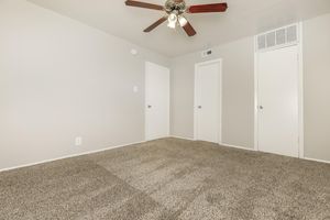 unfurnished carpeted bedroom with closed doors