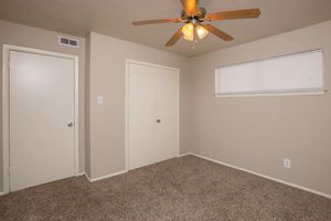 carpeted bedroom with closed doors