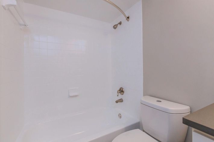 a white tub sitting next to a shower