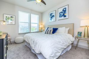 a bedroom with a white comforter 
