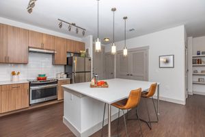 a kitchen with orange chairs