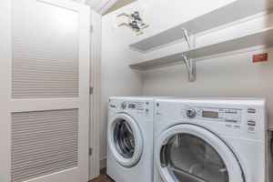 a front loading washer and dryer in the laundry closet