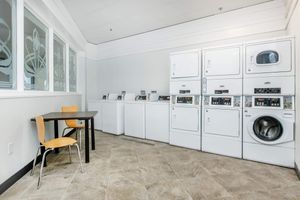 a kitchen with a stove and a chair in a room