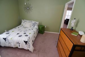 a bedroom with a bed and painted green