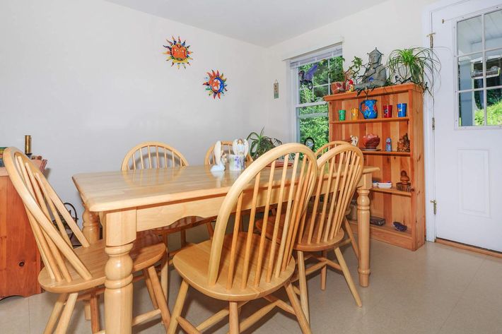 a dining room table in front of a wooden chair