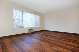 a large empty room with a wood floor