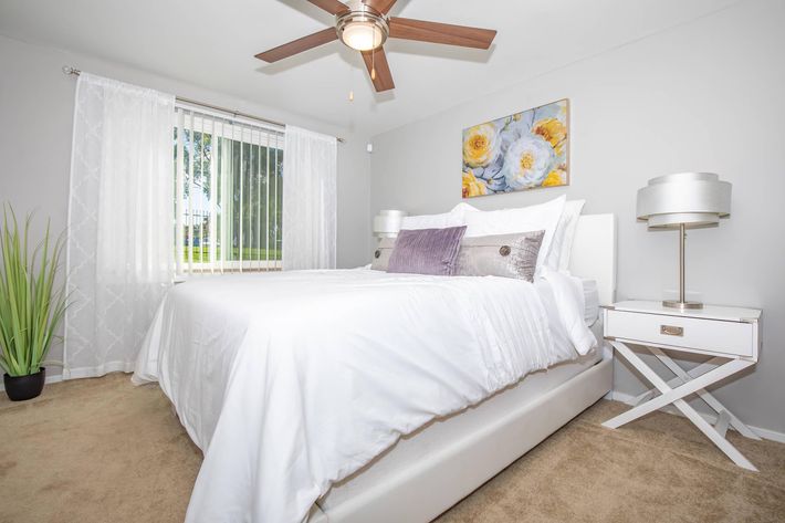 a large white bed sitting in a room