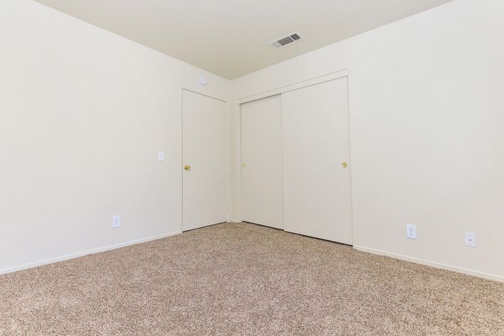 Unfurnished bedroom with closed doors