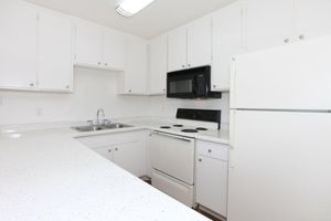 a white refrigerator freezer sitting inside of a kitchen