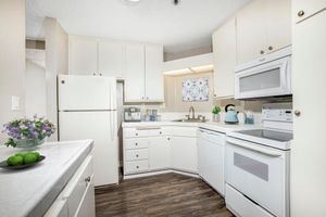 Kitchen with Wood-Style Flooring and White Cabinets