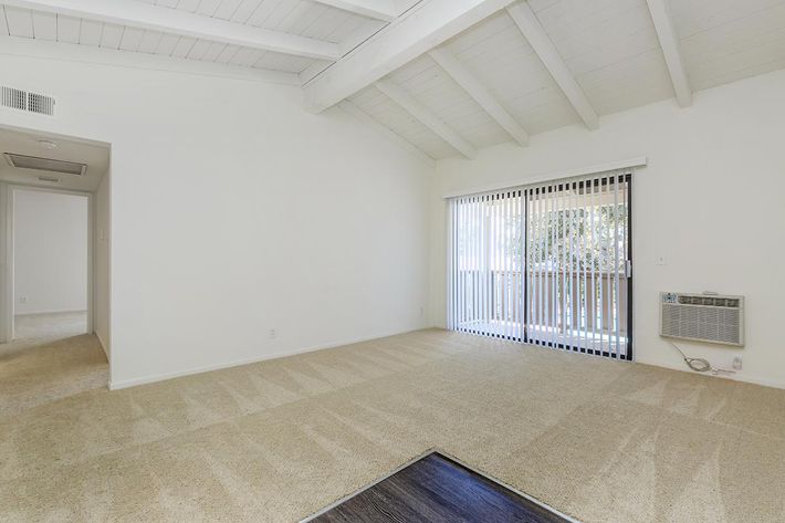 Carpeted living room with sliding glass doors