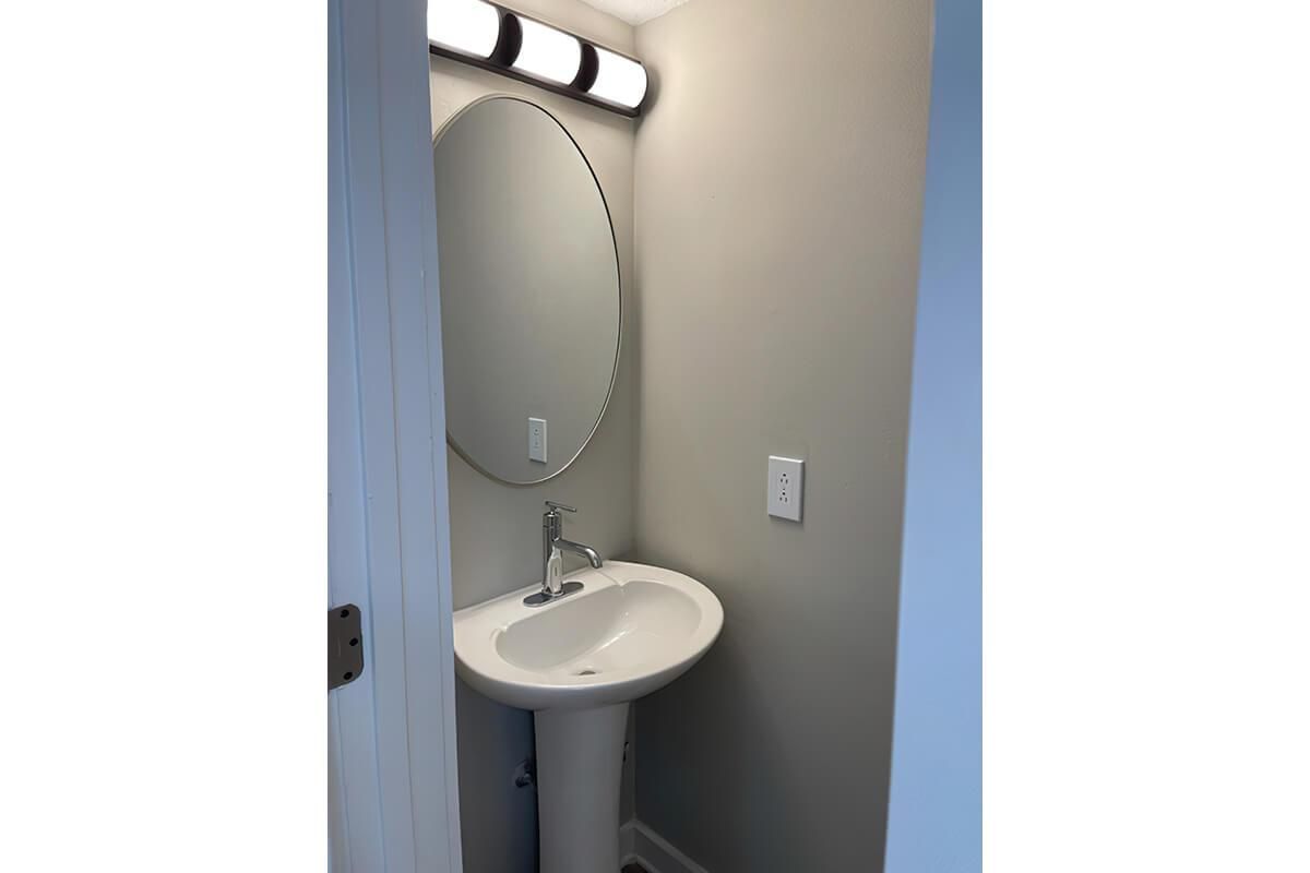 bathroom sink with large mirror