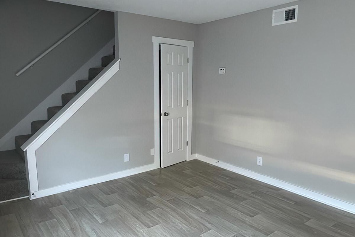 living area with stairs and a closet