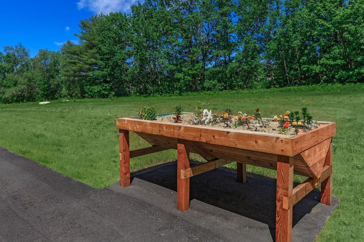a wooden bench sitting in front of a picnic table
