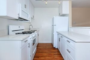 a kitchen with a white stove top oven