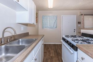 a kitchen with a sink and a stove top oven
