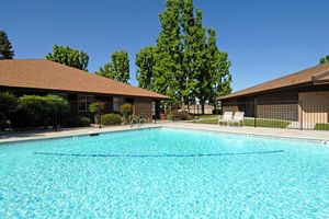 Redwood Glen Apartments community pool with green trees