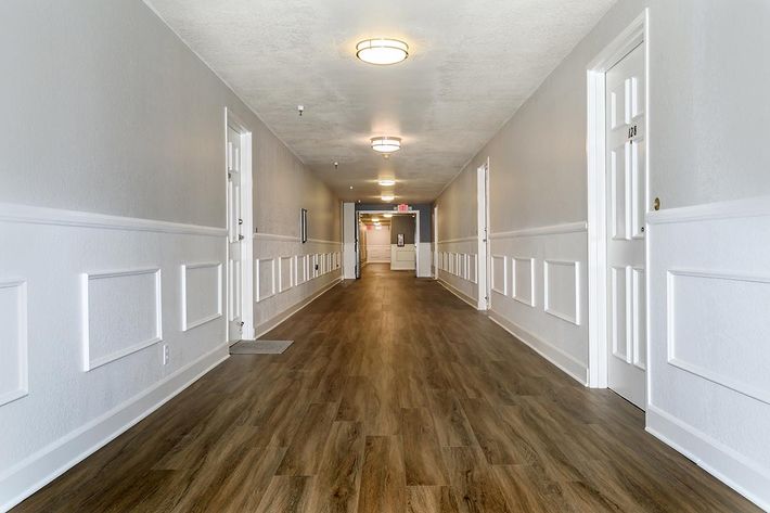 Heritage Pointe Senior Apartments hallway with wooden floors