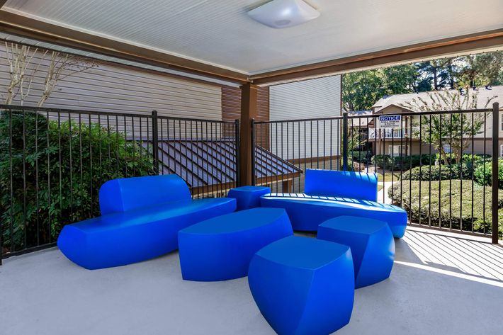 a living room with a blue umbrella