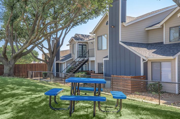 a blue bench in front of a house
