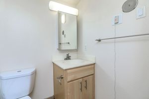 Unfurnished bathroom with wooden cabinets