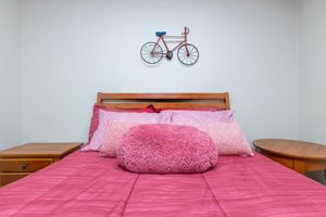 a bedroom with a pink blanket