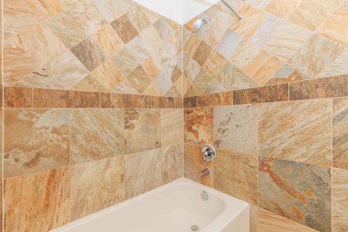 GORGEOUS CERAMIC TILE AND TUB SURROUNDS IN SELECT HOMES