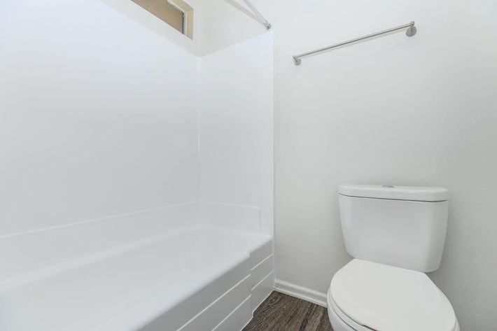 Vacant bathroom with wooden floors
