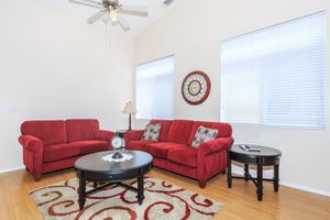 a large red chair in the living room