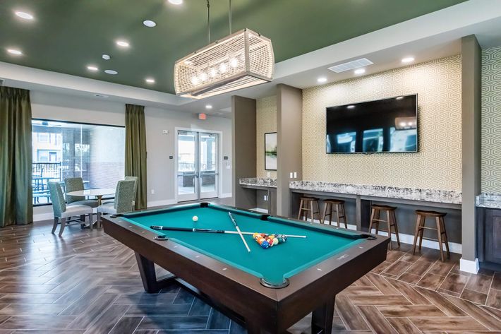 a large empty room with a pool table
