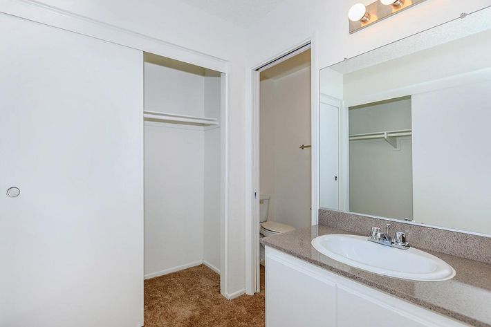 Bathroom sink with open sliding closet door