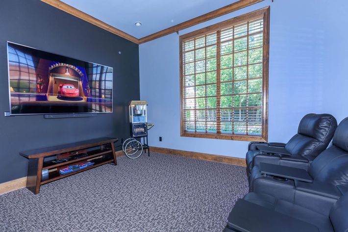 a living room with a television and a window